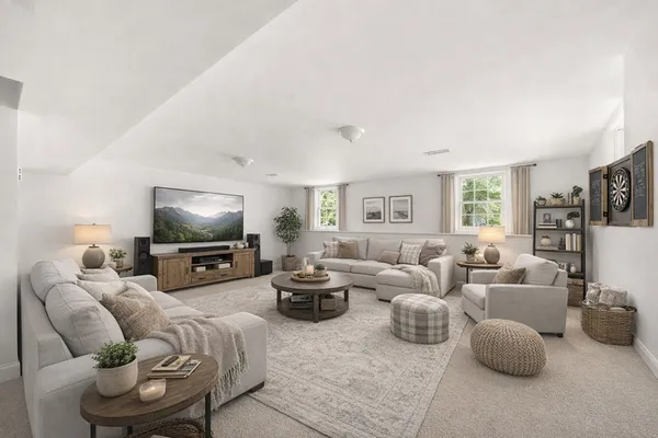 a living room with furniture a flat screen tv and a fireplace