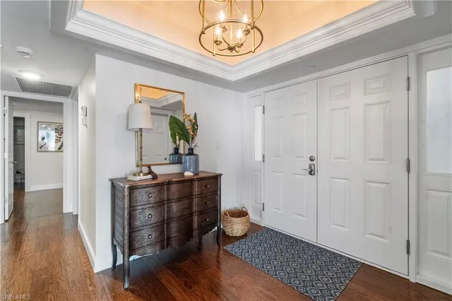 a bedroom with bed and wooden floor