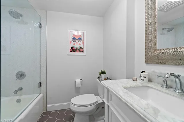 a kitchen with a stove a sink and a potted plant next to a window