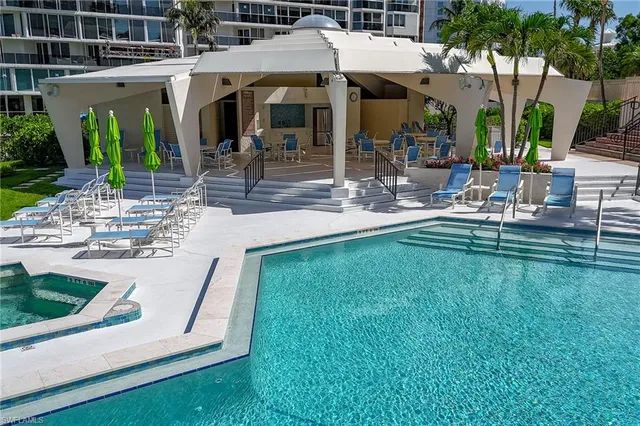 a vase of flowers sitting on a table with a potted plant