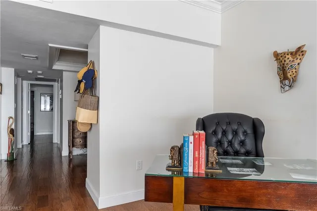 a view of hallway with wooden floor and stairs