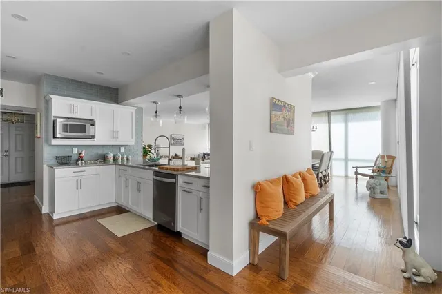 a kitchen with sink and white cabinets