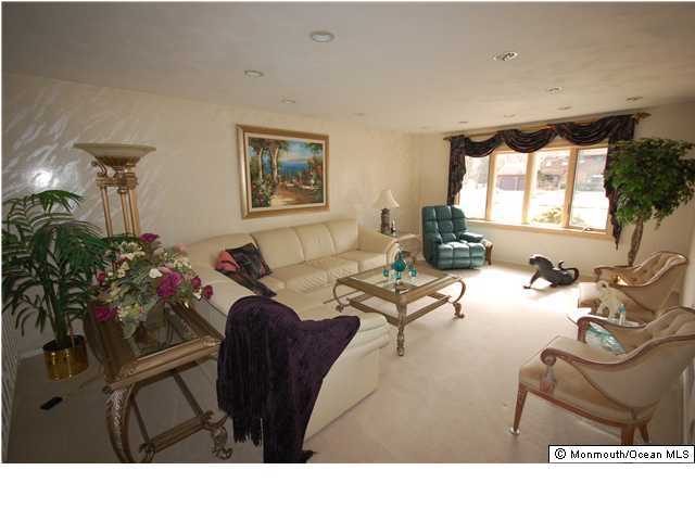 22 Farm Tree Road Manalapan, NJ 07726 - Photo 3 of 3 a living room with furniture potted plant and a window