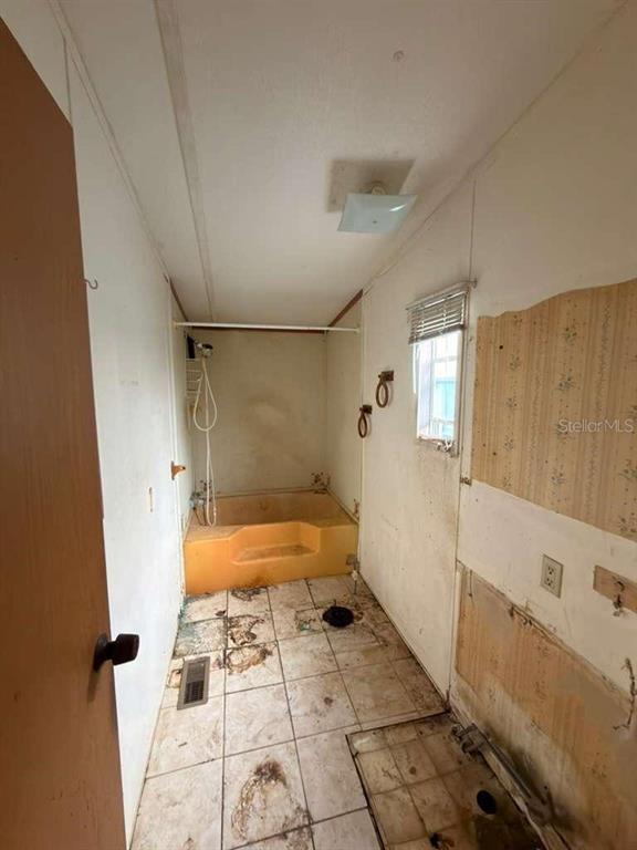 9519 Clyde Street Hudson, FL 34669 - Photo 11 of 11 a bathroom with a bathtub and a shower