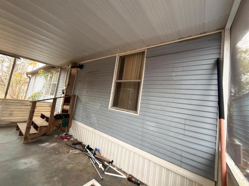 9519 Clyde Street Hudson, FL 34669 - Photo 4 of 11 a view of a balcony with chair and wooden floor
