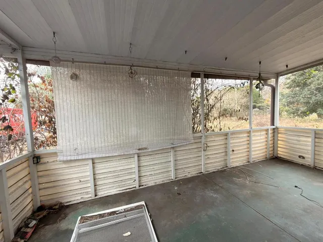 a view of a room with furniture and a window