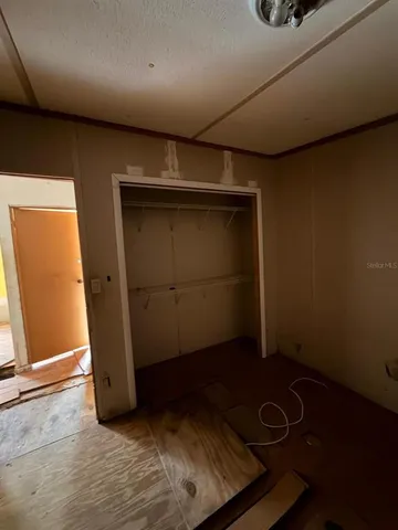 a bathroom with a shower and a tiled wall