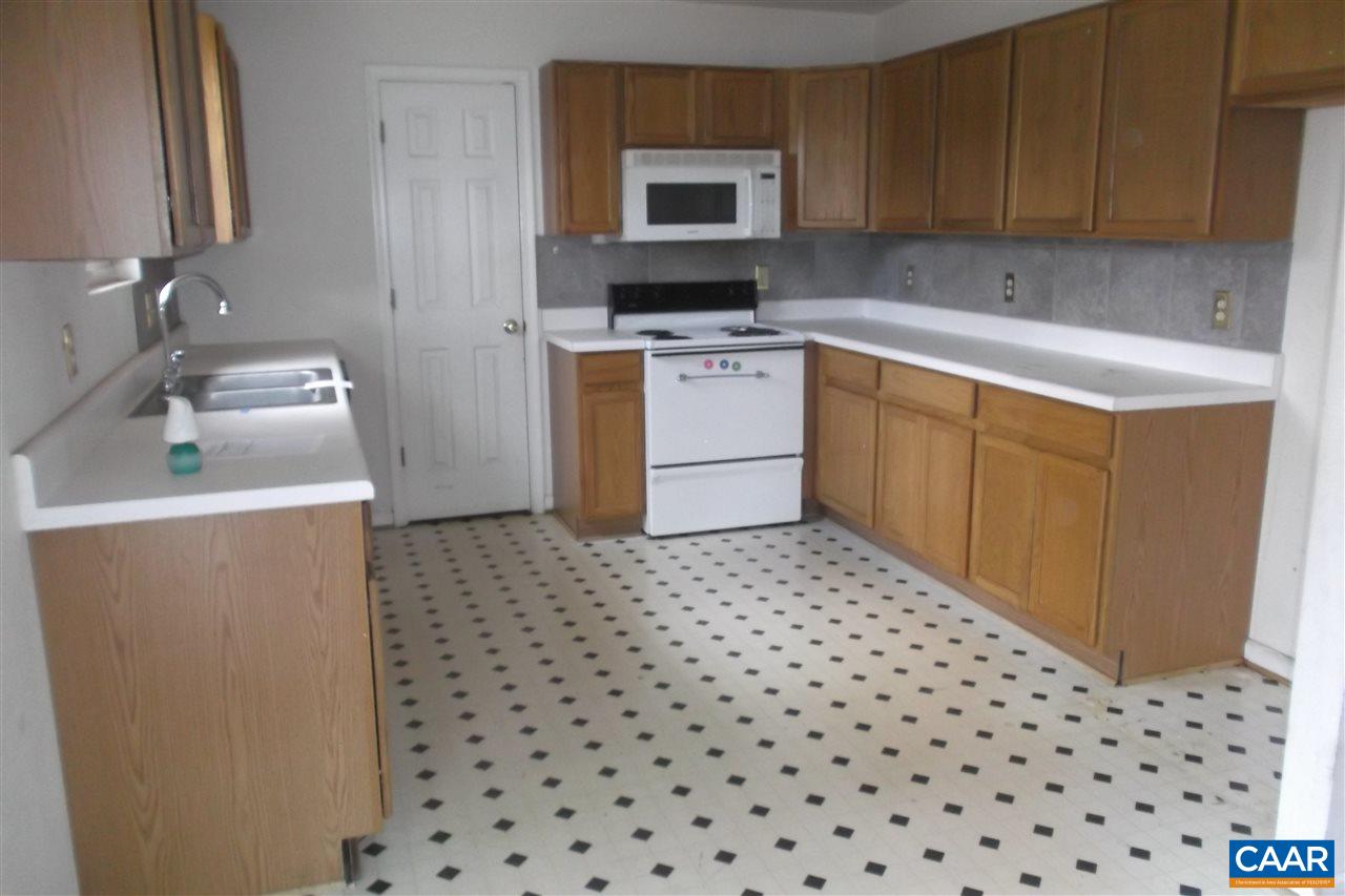 176 Old Farm Road Ruckersville, VA 22968 - Photo 4 of 7 a kitchen with a sink a stove top oven and white cabinets