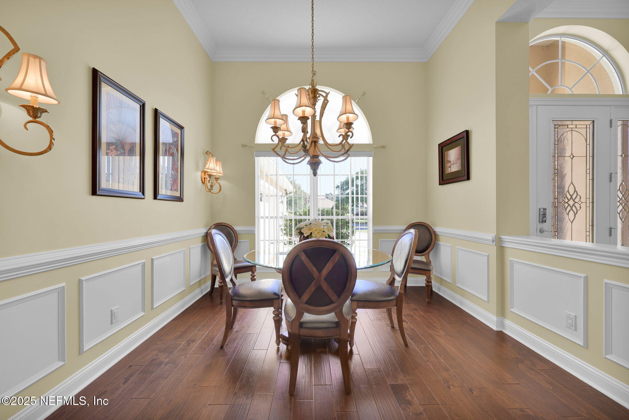 2049 River's Own Road St. Augustine, FL 32092 - Photo 7 of 63 a dining room with wooden floor a chandelier a glass table and chairs