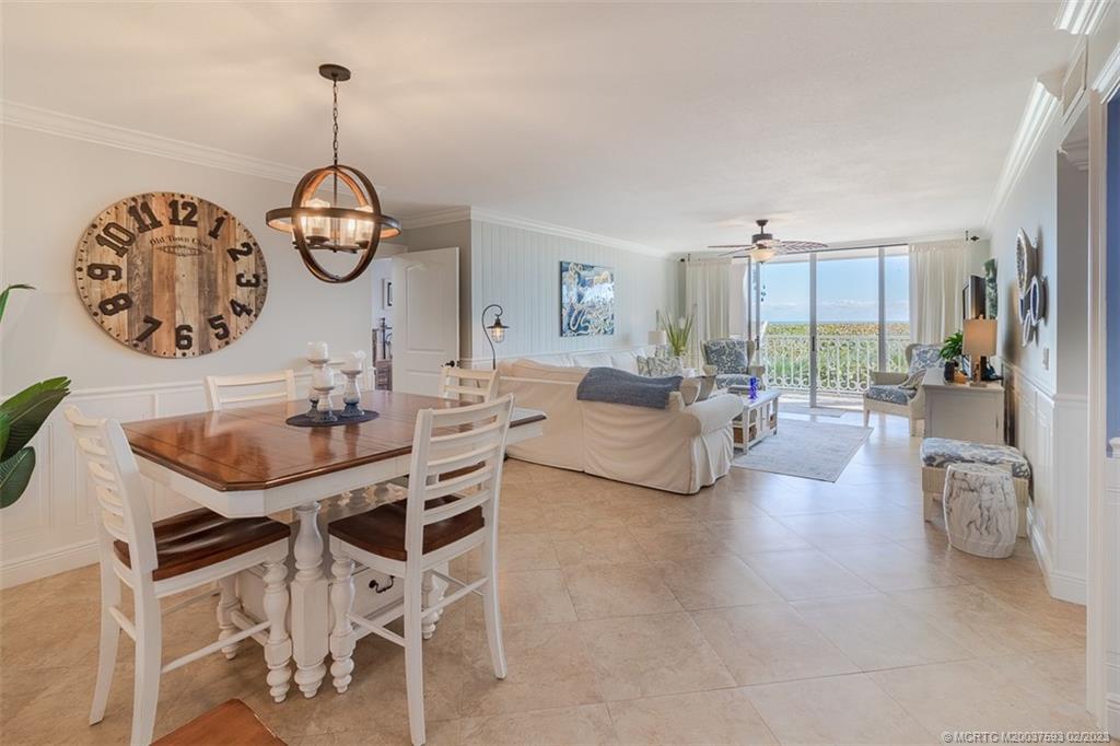 1701 Northeast Ocean Boulevard, Unit 103 Stuart, FL 34996 - Photo 13 of 46 a living room with furniture a clock and a large window