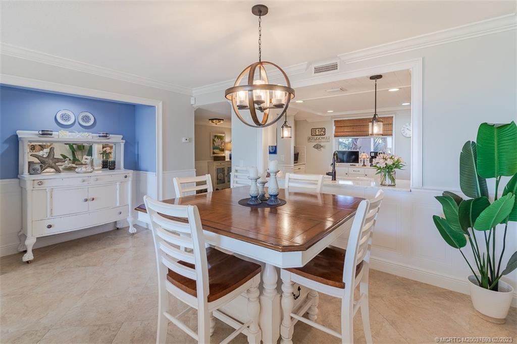 1701 Northeast Ocean Boulevard, Unit 103 Stuart, FL 34996 - Photo 14 of 46 a dining room with furniture and window