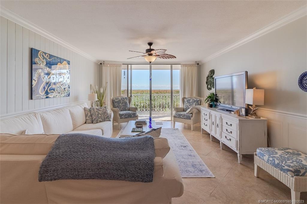 1701 Northeast Ocean Boulevard, Unit 103 Stuart, FL 34996 - Photo 16 of 46 a living room with furniture large window and flat screen tv
