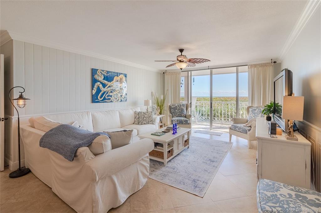1701 Northeast Ocean Boulevard, Unit 103 Stuart, FL 34996 - Photo 17 of 46 a living room with furniture and a large window