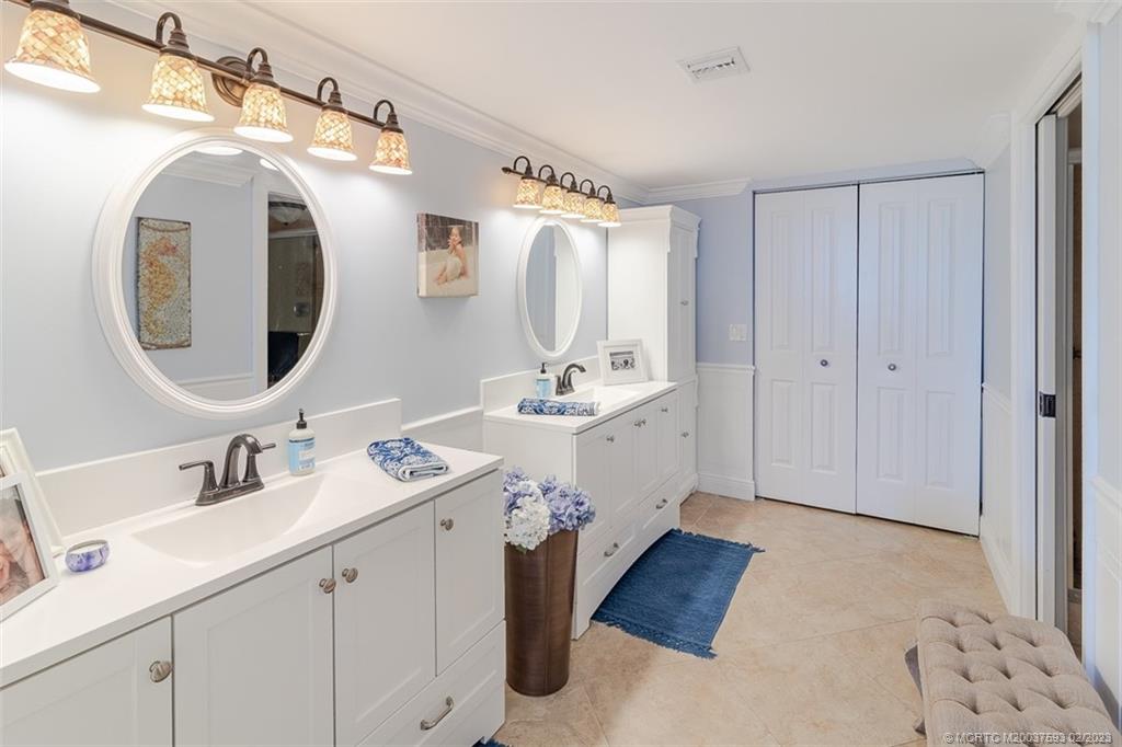 1701 Northeast Ocean Boulevard, Unit 103 Stuart, FL 34996 - Photo 20 of 46 a bathroom with a double vanity sink mirror and
