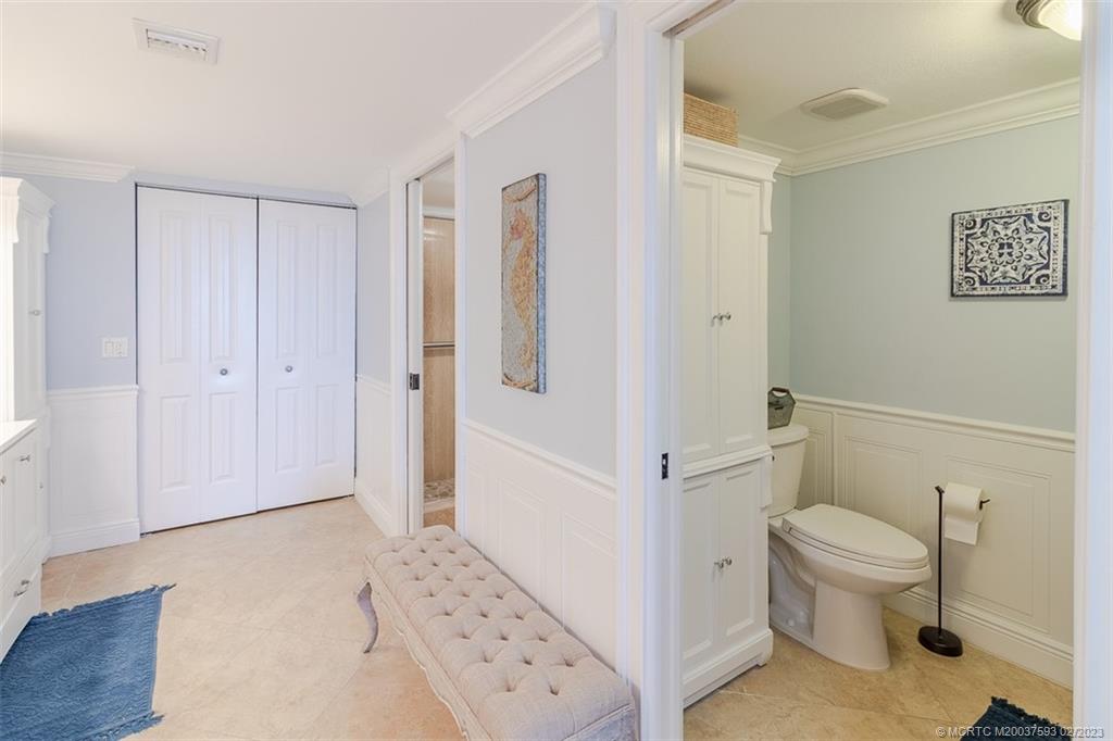 1701 Northeast Ocean Boulevard, Unit 103 Stuart, FL 34996 - Photo 23 of 46 a bathroom with a toilet and a shower
