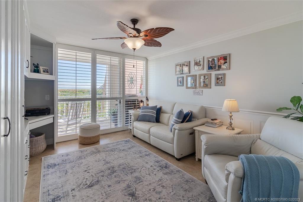 1701 Northeast Ocean Boulevard, Unit 103 Stuart, FL 34996 - Photo 24 of 46 a living room with furniture and a flat screen tv