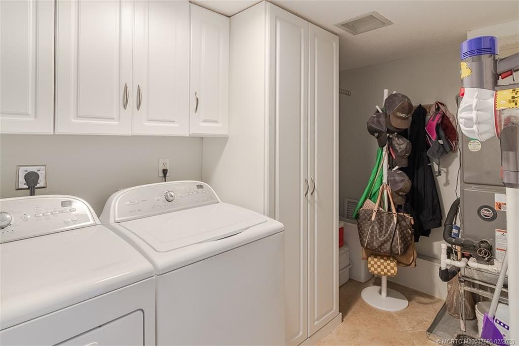1701 Northeast Ocean Boulevard, Unit 103 Stuart, FL 34996 - Photo 29 of 46 a utility room with dryer and washer