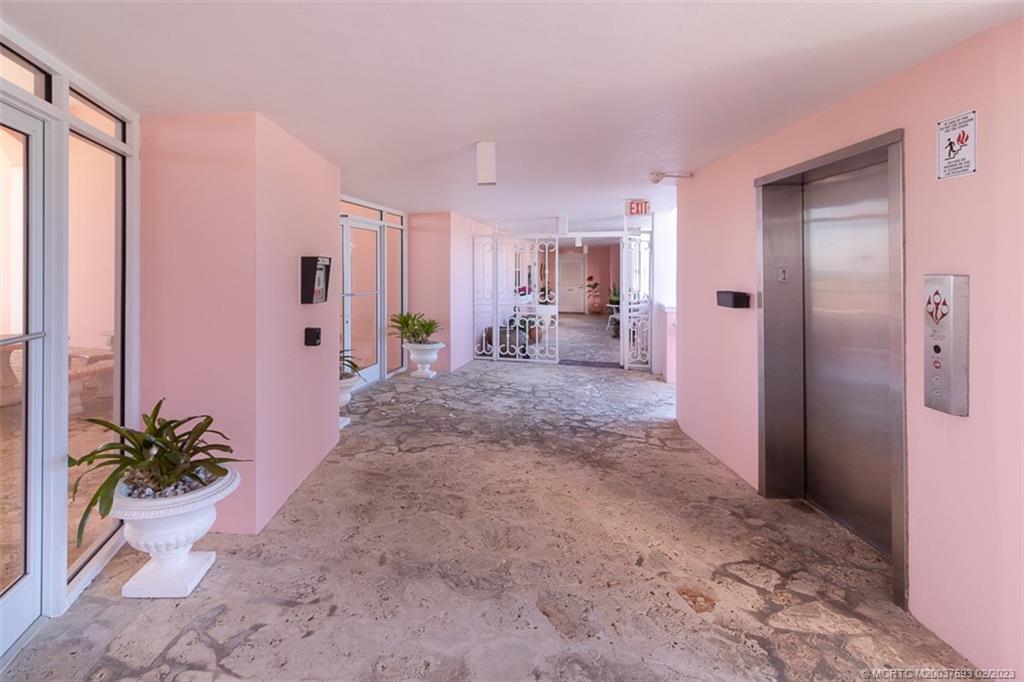 1701 Northeast Ocean Boulevard, Unit 103 Stuart, FL 34996 - Photo 38 of 46 a view of a hallway to a livingroom with furniture and an empty room