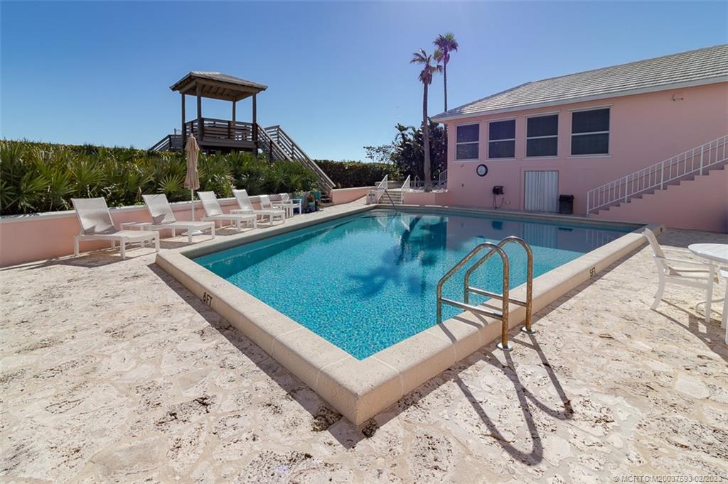 1701 Northeast Ocean Boulevard, Unit 103 Stuart, FL 34996 - Photo 41 of 46 a view of a swimming pool with a patio