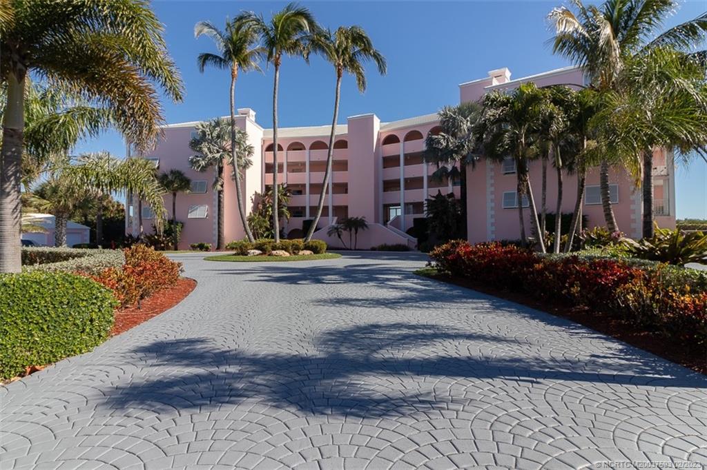 1701 Northeast Ocean Boulevard, Unit 103 Stuart, FL 34996 - Photo 45 of 46 a view of a palm trees front of a house