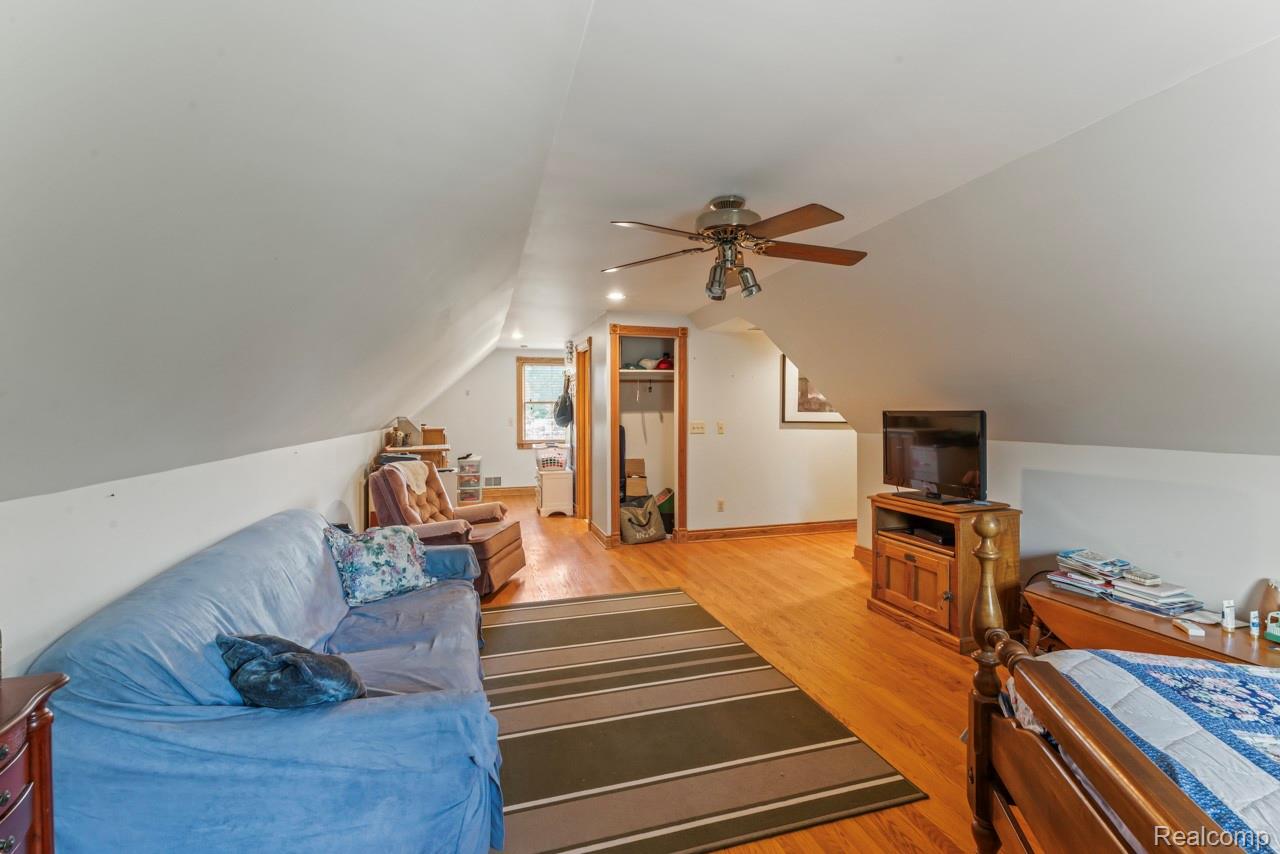 1591 Baldwin Road Lapeer, MI 48446 - Photo 17 of 46 Living room featuring light wood finished floors, lofted ceiling, and a ceiling fan