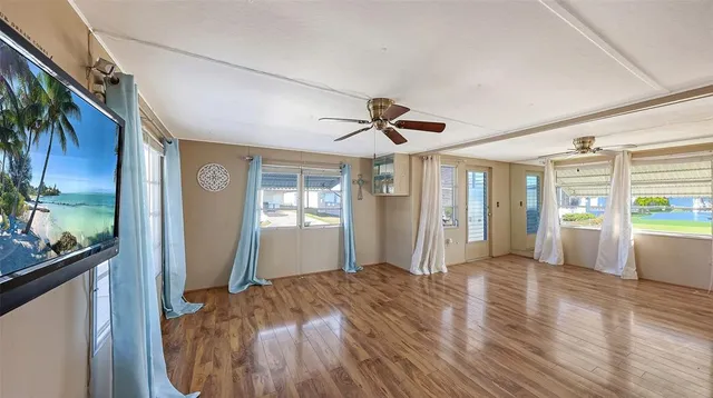 a view of a kitchen with a sink a refrigerator and window