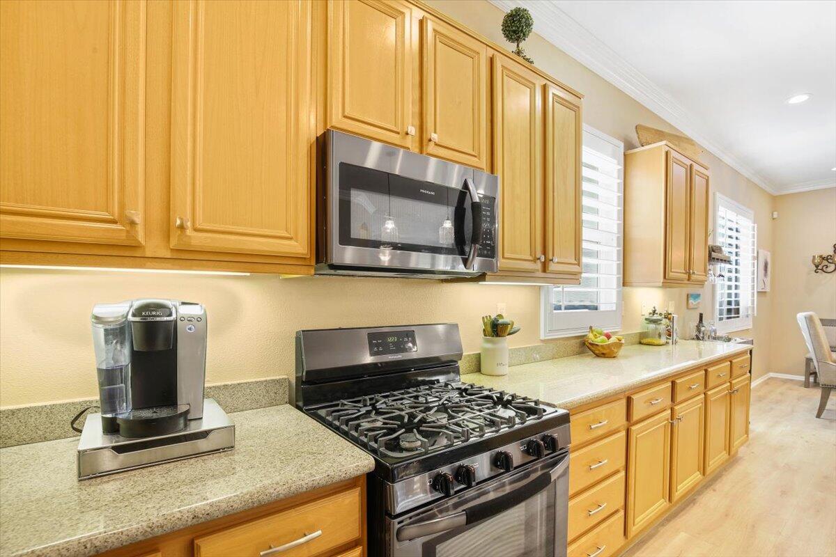 49465 Lewis Road Indio, CA 92201 - Photo 13 of 30 a kitchen with stainless steel appliances granite countertop a stove a sink and a microwave