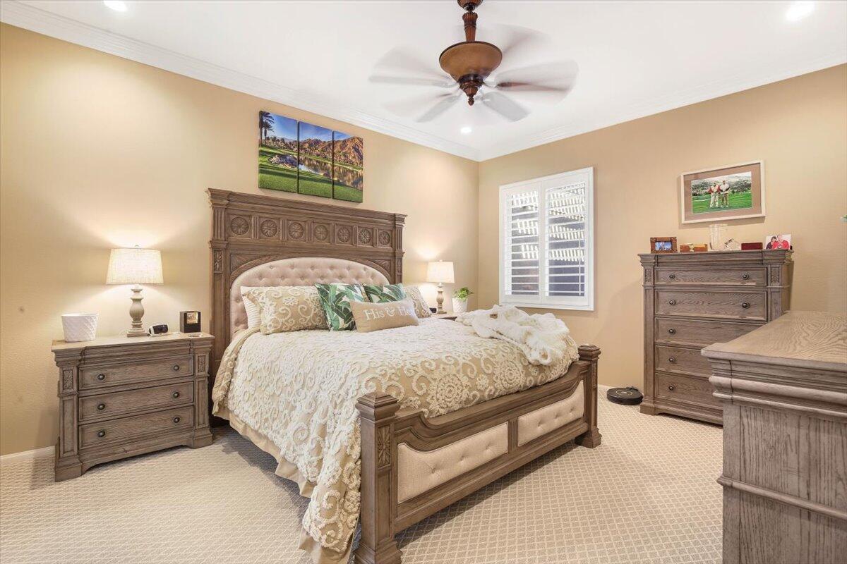 49465 Lewis Road Indio, CA 92201 - Photo 15 of 30 a bedroom with a bed and a chandelier