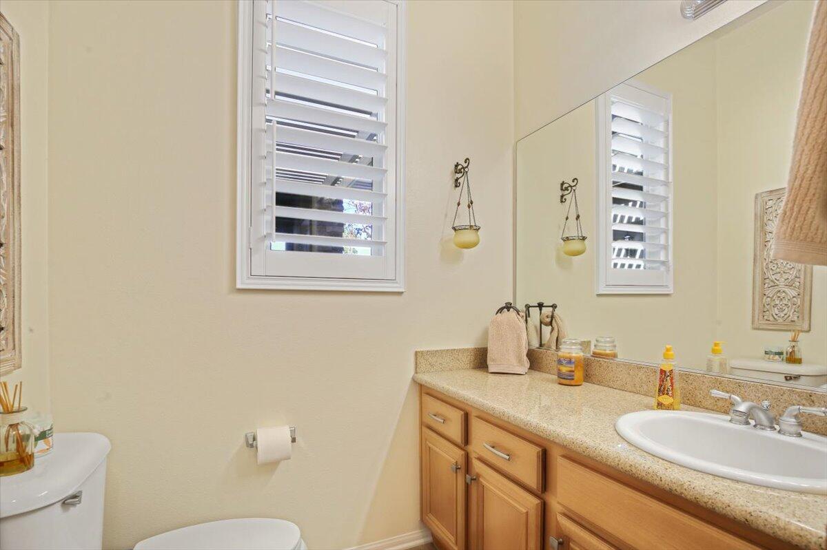 49465 Lewis Road Indio, CA 92201 - Photo 21 of 30 a bathroom with a granite countertop sink mirror and a toilet