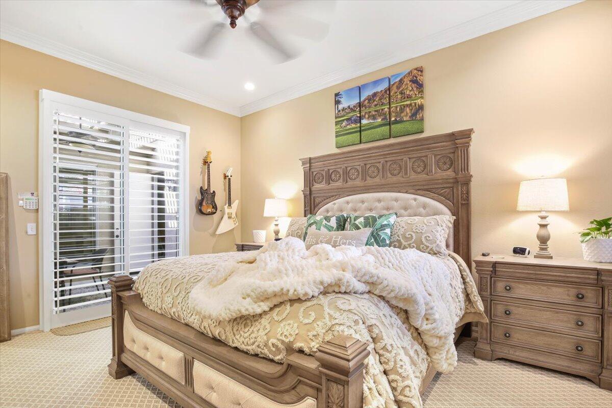 49465 Lewis Road Indio, CA 92201 - Photo 8 of 30 a bedroom with a bed and a chandelier
