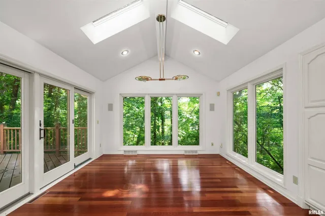 a view of a livingroom with entryway wooden shelves and closet