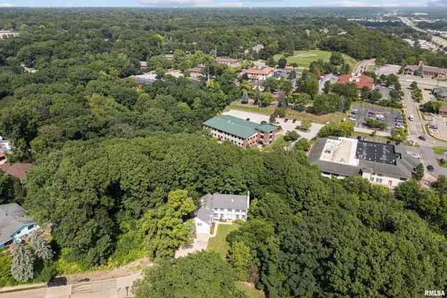 an aerial view of residential house with parking space and trees