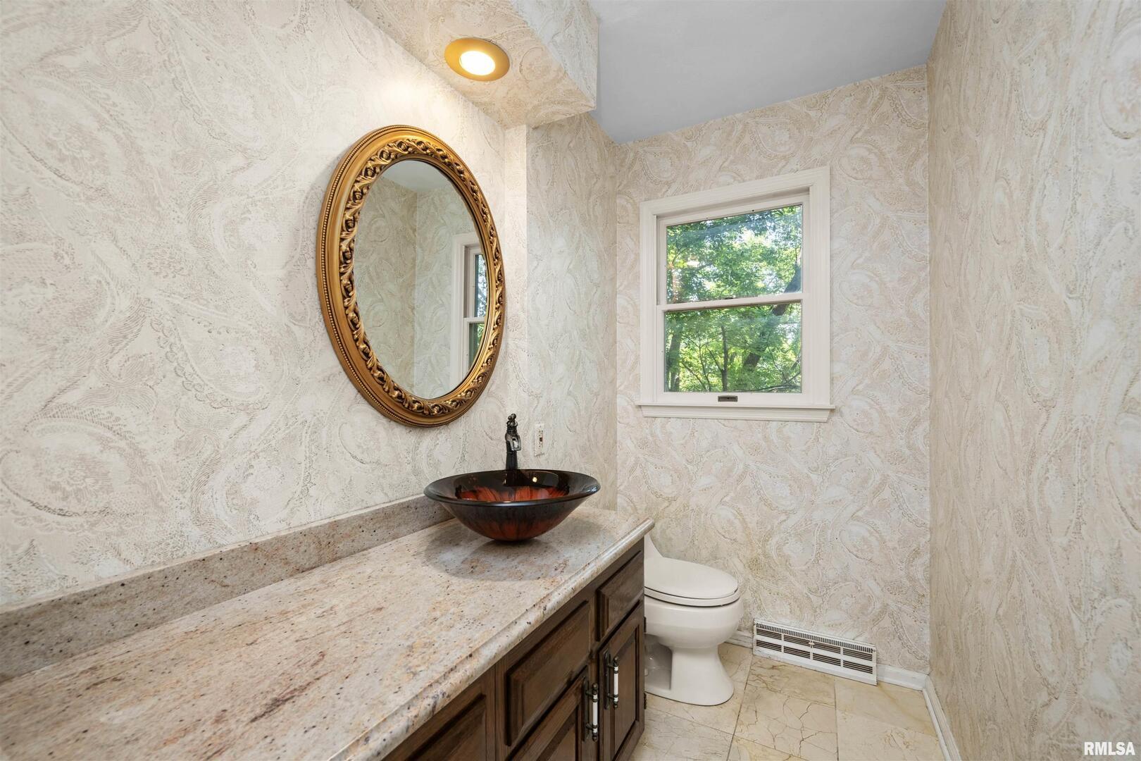 5 White Oak Court Moline, IL 61265 - Photo 31 of 57 a bathroom with a granite countertop toilet and a sink