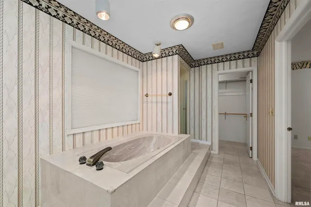 a bathroom with a granite countertop toilet a sink and a mirror