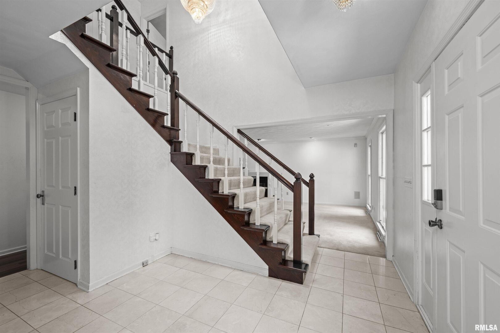 5 White Oak Court Moline, IL 61265 - Photo 5 of 57 a view of staircase with lots of frames and door