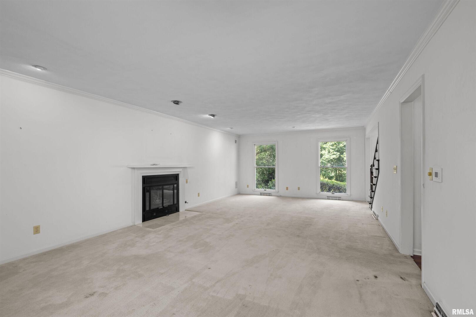 5 White Oak Court Moline, IL 61265 - Photo 9 of 57 an empty room with windows and fireplace