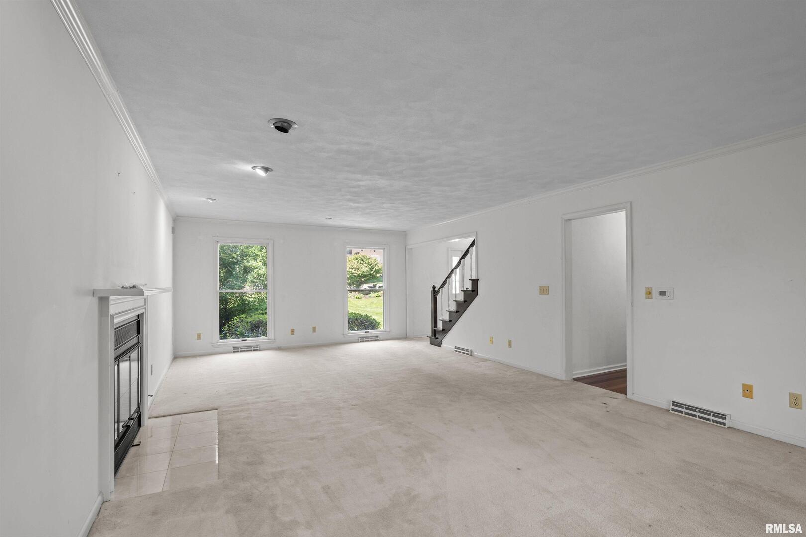 5 White Oak Court Moline, IL 61265 - Photo 10 of 57 a view of a big room with windows and chandelier