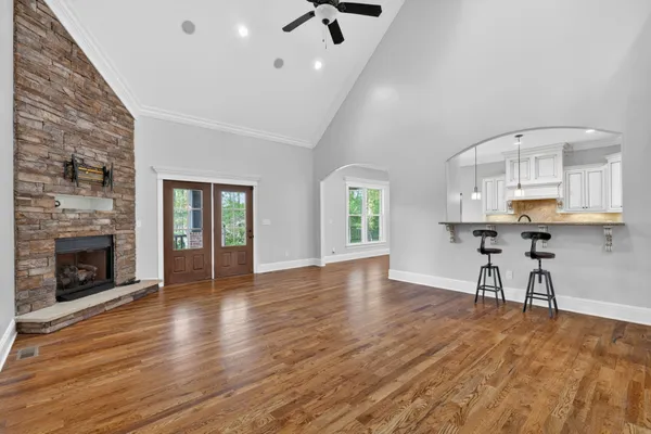 a dining room with furniture a large window and wooden floor