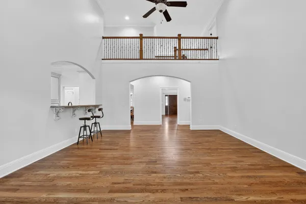 a dining room with furniture a chandelier and wooden floor