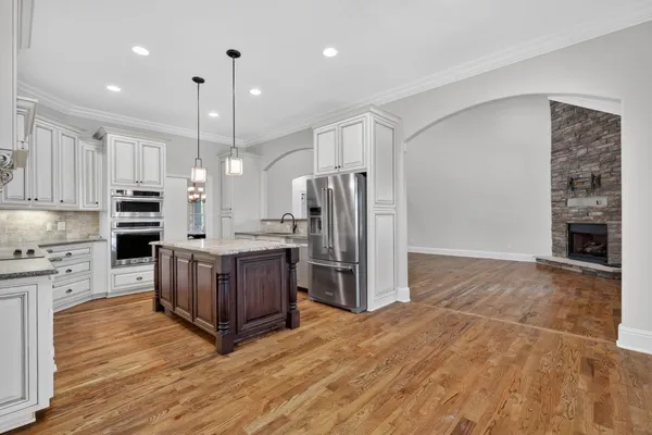 a kitchen with kitchen island a counter space a sink cabinets and stainless steel appliances