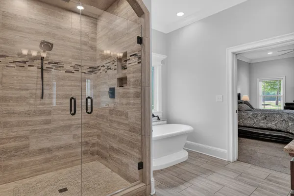 a bathroom with a granite countertop bathtub a sink and a mirror