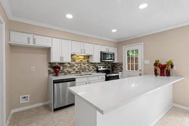 a kitchen with sink and windows