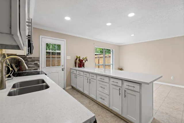 a kitchen with stainless steel appliances granite countertop a sink stove and cabinets