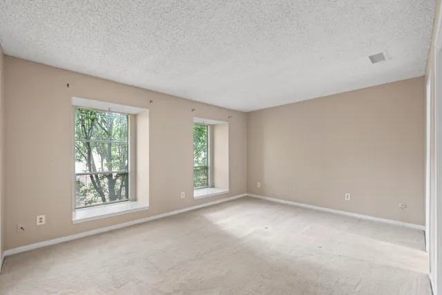 a view of an empty room and closet area