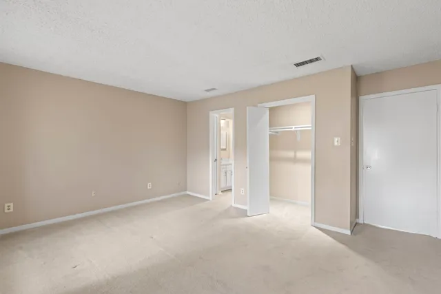 a view of an empty room with windows