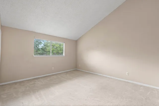 an empty room with a ceiling fan