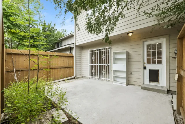 a view of a yard with plants and trees