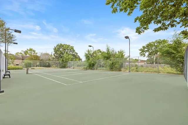 a living room with patio furniture and a floor to ceiling window