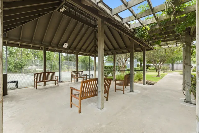 a backyard of a house with table and chairs