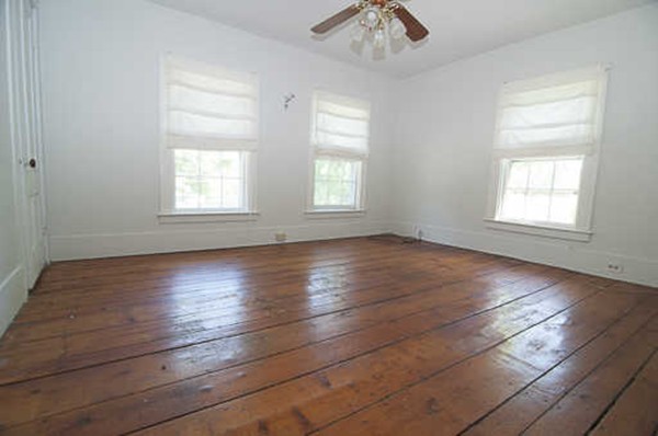 4 Shaw Street Medway, MA 02053 - Photo 18 of 25 an empty room with wooden floor chandelier and windows